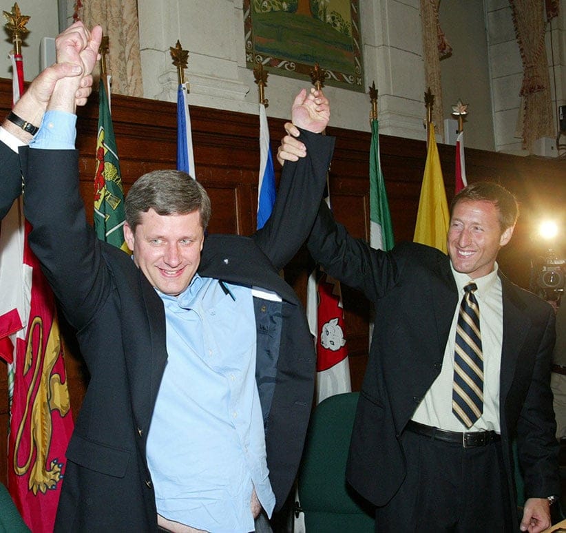 Conservative Party Leader Stephen Harper is welcomed by Conservative Party member Peter MacKay before they start a meeting with their new caucus in Ottawa on Wednesday July 7, 2004. Harper received long, loud applause Wednesday as he met with his new 99-member national caucus for the first time since the June 28 election. (Fred Chartrand/CP)