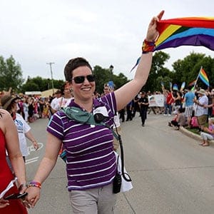 Michelle McHale, Karen Phillips and Chris Plett lead thousands of people during the first Pride march in Steinbach, Manitoba, Saturday, July 9, 2016. (Trevor Hagan/CP)