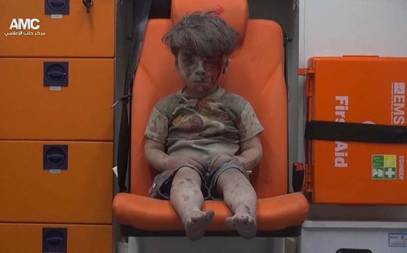 In this frame grab taken from video provided by the Syrian anti-government activist group Aleppo Media Center (AMC), a child sits in an ambulance after being pulled out or a building hit by an airstirke, in Aleppo, Syria, Wednesday, Aug. 17, 2016. Syrian opposition activists reported an airstrikes on the al-Qaterji neighborhood in Aleppo late Wednesday. (Aleppo Media Center/AP)