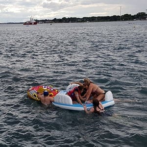 A Canadian Coast Guard ship tows floatation devices used by U.S. partiers to the Canadian side of the St. Clair River between Michigan and Ontario on August 21, 2016. About 1,500 Americans ended up in Canada after getting hit by strong wind and rain.  (Canadian Coast Guard/Reuters)