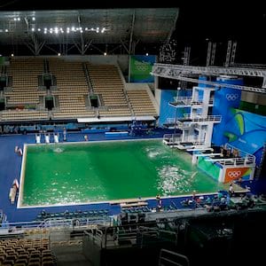 The water of the diving pool at right appears a murky green, in stark contrast to the pool's previous day's color and also that of the clear blue water in the second pool for water polo at the venue as divers train in the Maria Lenk Aquatic Center at the 2016 Summer Olympics in Rio de Janeiro, Brazil, Tuesday, Aug. 9, 2016. (AP Photo/Matt Dunham)