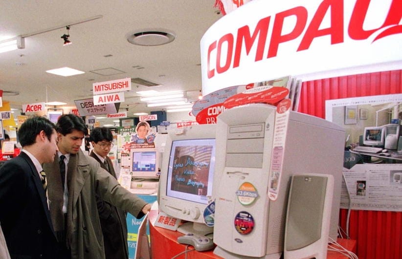 Consumers try one of the latest desktop computers from Compaq in 1997 - Reuters