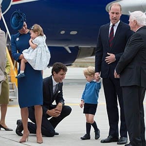 Prime Minister Justin Trudeau, centre, kneels to talk to Prince George as his father The Duke of Cambridge speaks with Governor General David Johnston, right, and The Duchess of Cambridge holds their daughter Princess Charlotte upon arrival in Victoria, B.C., on Saturday, September 24, 2016. (Jonathan Hayward/CP)