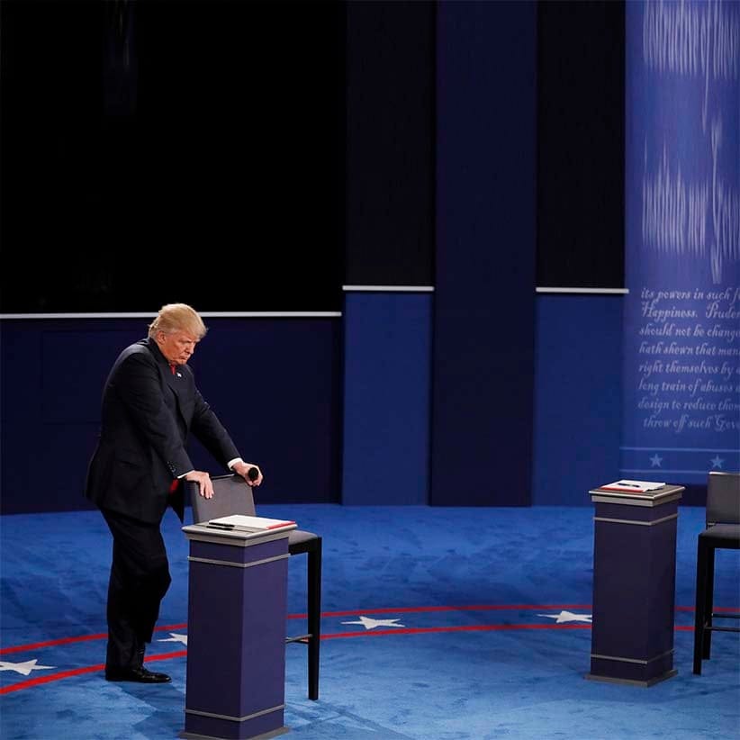 Republican U.S. presidential nominee Donald Trump listens as Democratic U.S. presidential nominee Hillary Clinton speaks during their presidential town hall debate with at Washington University in St. (Shannon Stapleton/Reuters)