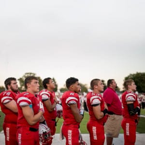 The Port Clinton High School football team stand for the national anthem before its homecoming game on Oct. 7. (Photograph by Nick Iwanyshyn)