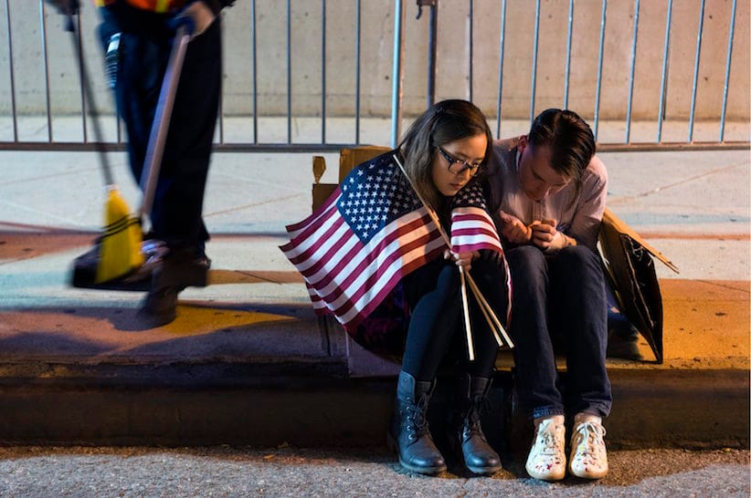 People sit outside the Jacob Javits Center waiting for election results following a rally for Democratic presidential candidate Hillary Clinton in New York Wednesday, Nov. 9, 2016. (AP Photo/Craig Ruttle)