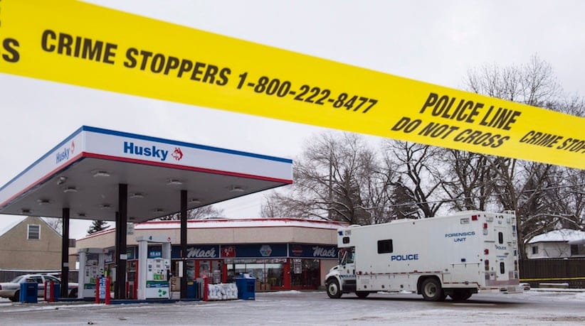 Homicide detectives investigate at a Mac's convenience store in Edmonton on Friday, December 18, 2015. THE CANADIAN PRESS/John Ulan