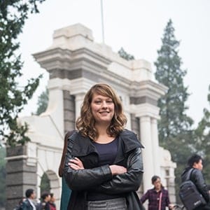 Chardaye Bueckert, a Shwarzman Scholar in Beijing, poses in front of the original tsinghua second school gate at the Tsinghua University Campus in Beijing, China. (Photograph by Shawn Koh)
