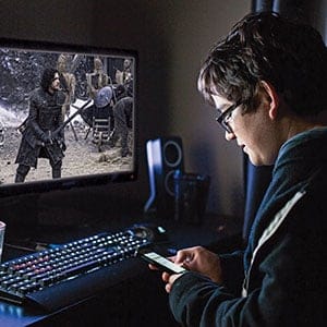 A student watches Game of Thrones on his computer. (Photo illustration by Levi Nicholson and Richard Redditt)