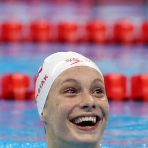 Canada's Penny Oleksiak smiles after winning the gold medal and setting a new olympic record in the women's 100-meter freestyle during the swimming competitions at the 2016 Summer Olympics. (Lee Jin-man/AP)