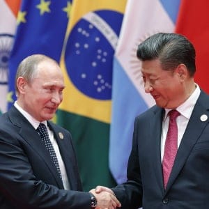 Chinese President Xi Jinping shakes hands with Russian President Vladimir Putin to the G20 Summit. (Lintao Zhang/Getty Images)
