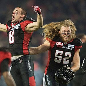 Ottawa Redblacks wide receiver Jake Harty (8) and Redblacks linebacker Tanner Doll (52) celebrate their victory over the Calgary Stampeders during overtime CFL Grey Cup action Sunday, November 27, 2016 in Toronto. (Nathan Denette/CP)