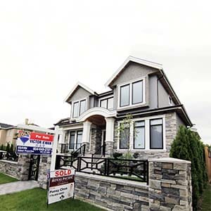 Realtors' signs are hung outside a newly sold property in a Vancouver, B.C., Canada neighbourhood where houses regularly sell for C$3-C$4 million (US$2.7-3.6 million) September 9, 2014. (Jim Tanner/Reuters)