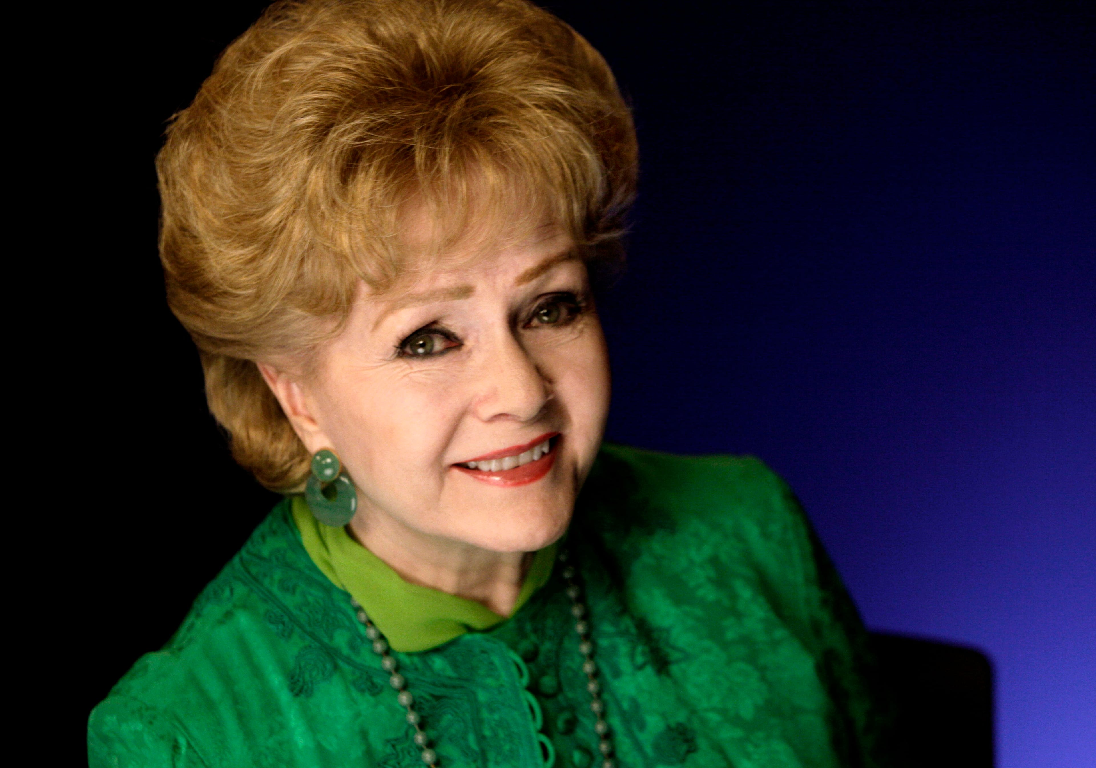 FILE - This Oct. 14, 2011 file photo shows actress Debbie Reynolds posing for a portrait in New York. Reynolds, star of the 1952 classic "Singin' in the Rain" died Wednesday, Dec. 28, 2016, according to her son Todd Fisher. She was 84. (AP Photo/Richard Drew, File)