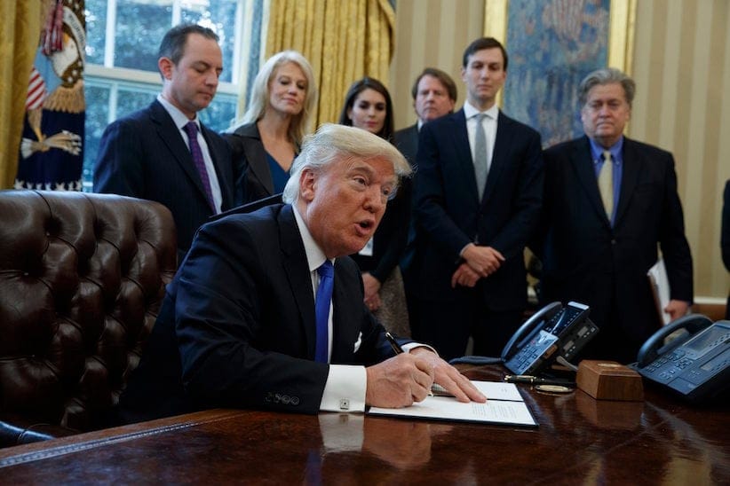 President Donald Trump signs an executive order on the Keystone XL pipeline, Tuesday, Jan. 24, 2017, in the Oval Office of the White House in Washington. (AP Photo/Evan Vucci)