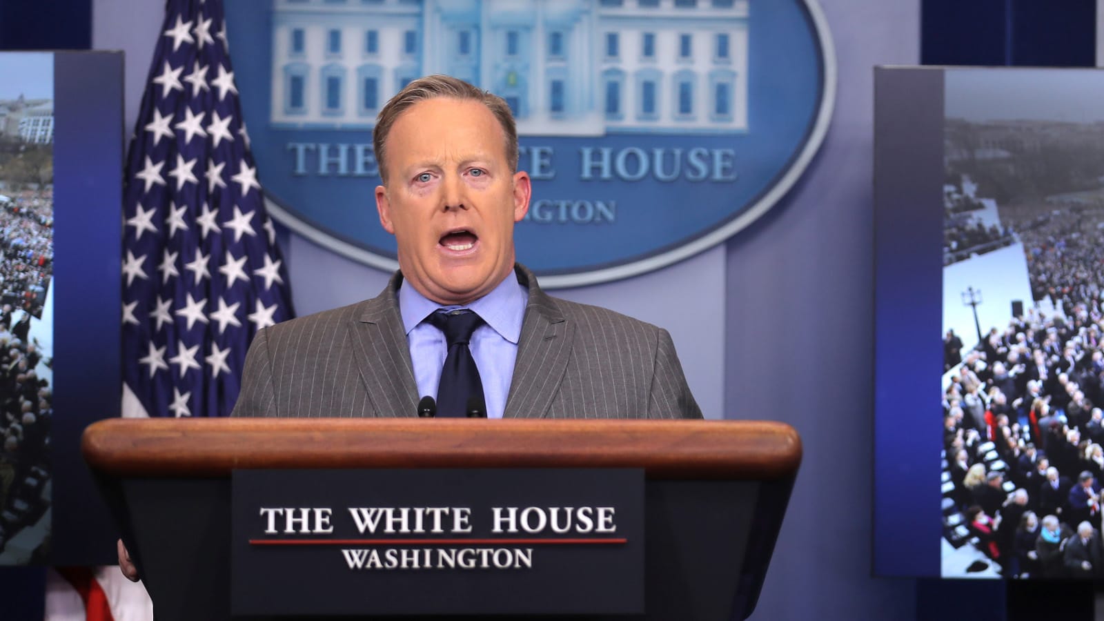Press Secretary Sean Spicer delivers a statement while television screen show a picture of U.S. President Donald Trump's inauguration at the press briefing room of the White House in Washington U.S., January 21, 2017. (Carlos Barria/Reuters)