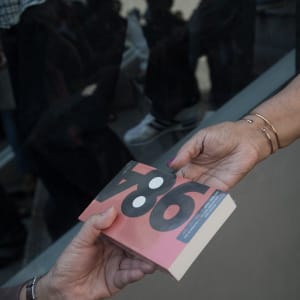 A demonstrator (R) gives George Orwell's book '1984' to a woman outside the Art and Cultural centre during a rally in Bangkok on February 14, 2015.  (Nicolas Asfouri/AFP/Getty Images)
