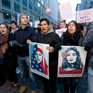 Demonstrators march on the street near a security checkpoint inaugural entrance, Friday, Jan. 20, 2017 in Washington, ahead of President-elect Donald Trump's inauguration. Protesters pitching diverse causes but united against the incoming president are making their mark on Inauguration Day.  (Jose Luis Magana/AP)