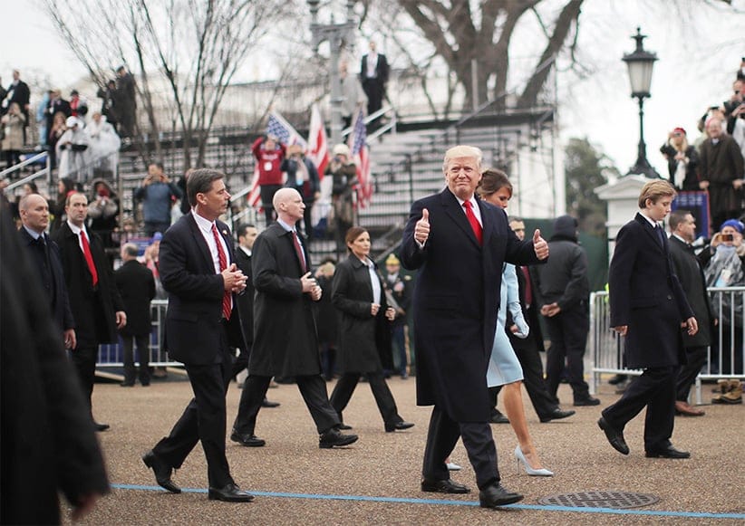 U.S. President Donald Trump gestures while walking with wife Melania and son Barron during the Inaugural Parade in Washington, January 20, 2017. Donald Trump was sworn in earlier as the 45th President of the United States.  (Carlos Barria/Reuters)