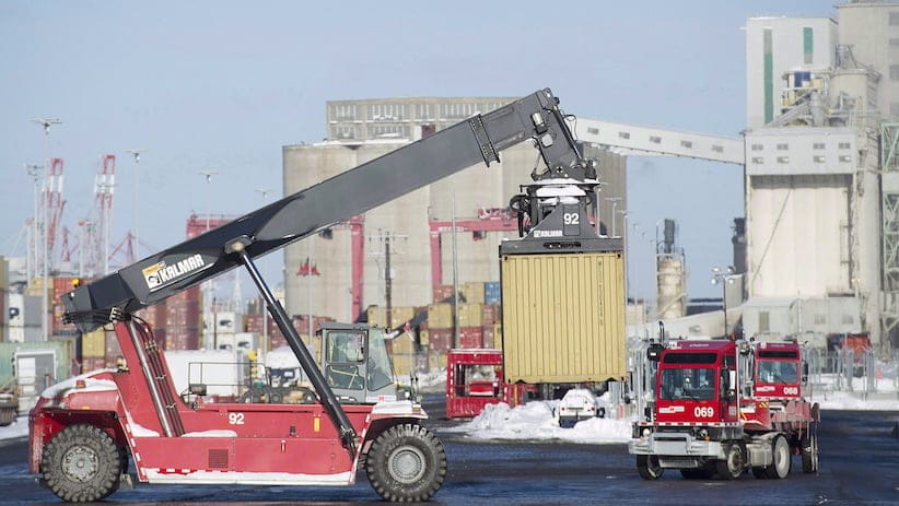 Trucks unload containers from cargo ships in the Port of Montreal in a January 4, 2016, file photo. THE CANADIAN PRESS/Graham Hughes