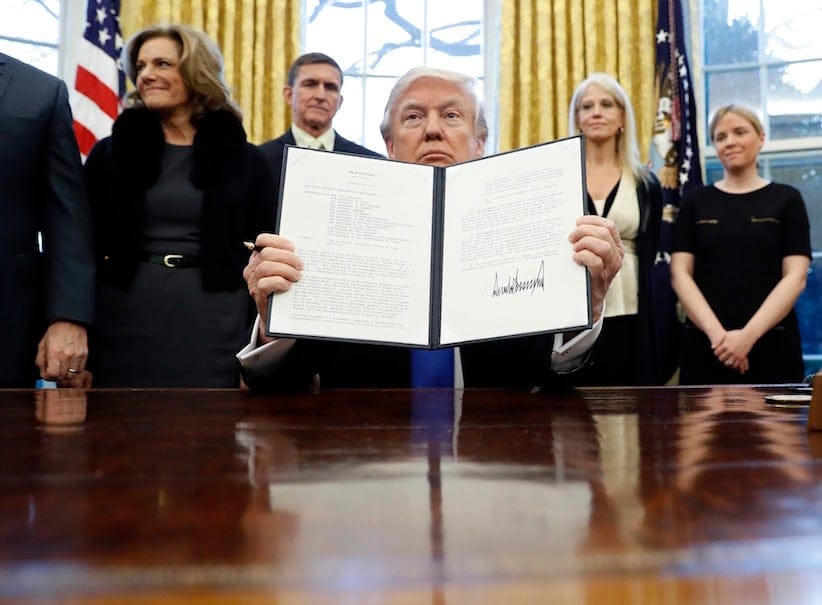 President Donald Trump holds up a signed Presidential Memorandum in the Oval Office in Washington. The document directs his administration to "develop a comprehensive plan to defeat ISIS." (AP Photo/Alex Brandon)