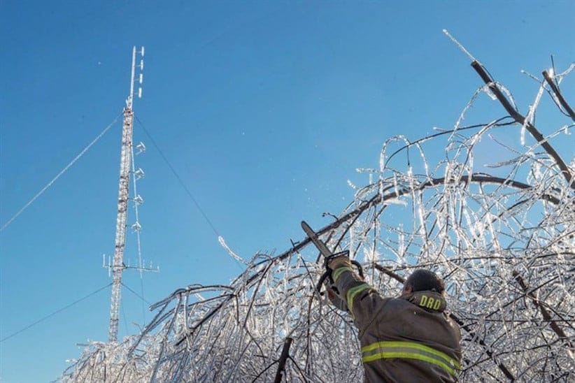 Members of the Baie Sainte Anne Fire Department clear a road so technicians can get to the emergency radio repeater tower to charge the batteries in Escuminac, N.B. on Sunday, Jan. 29, 2017. There are still about eight thousand customers awaiting the return of electricity in northern New Brunswick today, more than a week after the ice storm that wreaked havoc in the province.THE CANADIAN PRESS/Diane Doiron