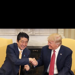 U.S. President Donald Trump, right, shakes hands with Shinzo Abe, Japan's prime minter, while posing for photographs before a joint news conference in the Oval Office of the White House in Washington, D.C., U.S., on Friday, Feb. 10, 2017.  (Chip Somodevilla/Pool/Bloomberg/Getty Images)