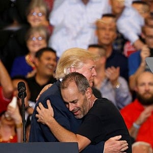 U.S. President Donald Trump hugs a supporter he invited onstage to speak during a "Make America Great Again" rally at Orlando Melbourne International Airport in Melbourne, Florida, U.S. February 18, 2017.  (Kevin Lamarque/Reuters)