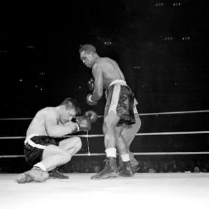 Canadian challenger Yvon Durelle is down in 11th round of Light-Heavyweight title fight just before losing to champion Archie Moore in Montreal, Quebec, Canada, Dec. 10, 1958.  (AP/CP)