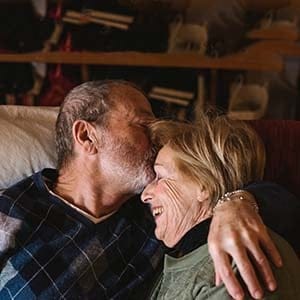 Happy and playful senior couple together at home.  (Simone Becchetti/Stocksy)