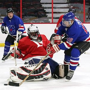 Conservative MP Blaine Calkins tries to get the puck around Liberal goalie Marc Miller during a charity hockey match in support of the Terry Fox Foundation at the Canadian Tire Centre in Ottawa. (Andrew Meade)