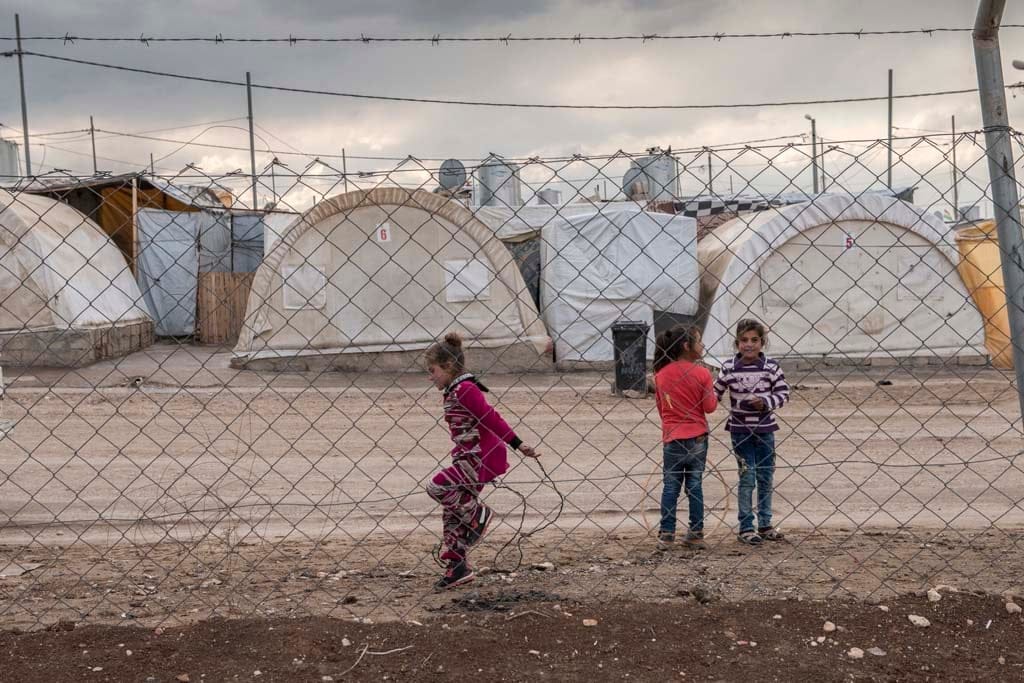 Children play within the Duhok refugee camp in Iraq (Photograph by 
Peter Bregg)