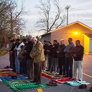 Congregation members hold prayer in the parking lot, on Sunday, November 15, 2015, after the only mosque in Peterborough, Ont., was deliberately set alight Saturday night. (THE CANADIAN PRESS/Christopher Katsarov)