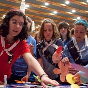Girl Guides of Canada members reach for pieces of cardboard and markers at the Girl Empower Challenge activity during the 100th year celebration of Girl Guides of Canada on Parliament Hill in Ottawa on Tuesday, March 9, 2010. (Pawel Dwulit/CP)