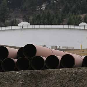 Replacement pipe is stored near crude oil storage tanks at Kinder Morgan's Trans Mountain Pipeline terminal in Kamloops, British Columbia, Canada November 15, 2016. (Chris Helgren/Reuters)