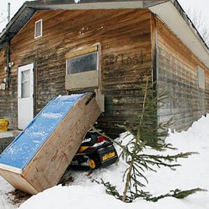 The outside of Pikangikum First Nation resident Juliette Turtle's home, Friday, January 5, 2007. Pikangikum First Nation is a remote-access community located on Pikangikum Lake, approximately 100 km northwest of Red Lake, Ont. Half of the 430 homes are falling apart and unfit to live in, yet continue to be occupied. Ninety per cent don’t have running water or indoor toilets. (John Woods/CP)