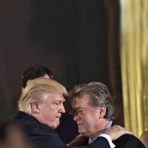 US President Donald Trump (L) congratulates Senior Counselor to the President Stephen Bannon during the swearing-in of senior staff in the East Room of the White House on January 22, 2017 in Washington, DC. (Mandel Ngan/AFP/Getty Images)