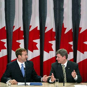 PREMIUM -- Progressive Conservative leader Peter MacKay (left) and Canadian Alliance leader Stephen Harper address the media at a news conference announcing a merger deal with the two parties, in Ottawa Thursday Oct 16, 2003. (Jonathan Hayward/CP)