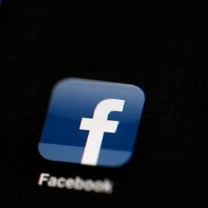 FILE - In this May 16, 2012 file photo, the Facebook logo is displayed on an iPad in Philadelphia.  Facebook is adding more Snapchat-like features to its app. The company says it wants to let people's cameras "do the talking" as more people are posting photos and videos instead of blocks of text. With the update coming to users starting Tuesday, March 28, 2017,  Facebook is adding a camera icon to the top left corner of its mobile app.. (AP Photo/Matt Rourke, File)