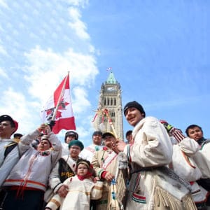 A group of young aboriginal people who travelled 1,600 kilometre on foot from the James Bay Cree community of Whapmagoostui, Quebec celebrate their arrival on Parliament hill in Ottawa, Monday, March 25, 2013. (Fred Chartrand/CP)