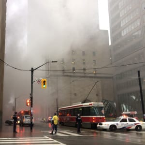 Smoke rises as police block off an intersection in the financial district after reports of a loud blast and heavy smoke could be seen in Toronto, Ontario, Canada May 1, 2017. (Jim Tanner/Reuters)
