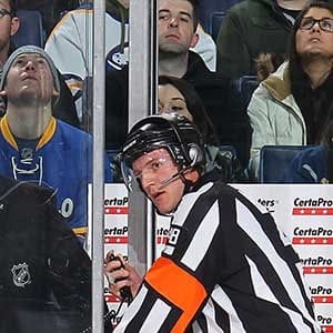 Referee Garrett Rank #48, working his first NHL game, awaits a video replay ruling during the game between the Buffalo Sabres and the Minnesota Wild on January 15, 2015 at the First Niagara Center in Buffalo, New York.  (Bill Wippert/NHLI/Getty Images)