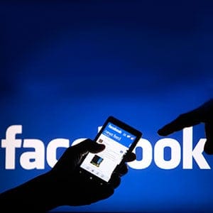 A smartphone user shows the Facebook application on his phone in the central Bosnian town of Zenica, in this photo illustration, May 2, 2013. Facebook Inc's mobile advertising revenue growth gained momentum in the first three months of the year as the social network sold more ads to users on smartphones and tablets, partially offsetting higher spending which weighed on profits. (Dado Ruvic/Reuters)