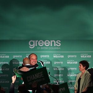 B.C. Green party leader Andrew Weaver is hugged by elected Adam Olsen, as Sonia Furstenau, (right) looks on during a speech to supporters at election headquarters at the Delta Ocean Pointe on election night in Victoria, B.C., on Wednesday, May 10, 2017.(Chad Hipolito/CP)