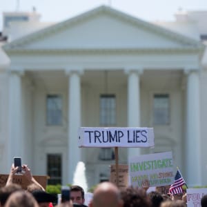A protester holds a placard in front of the White House during a protest demanding an independent investigation in the Trump/Russia ties after the firing of FBI Director James Comey in Washington, DC, May 10, 2017. (Jim Watson/AFP/Getty Images)