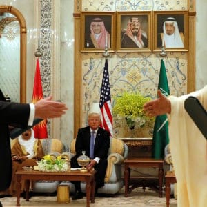 U.S. President Donald Trump (C) looks on as U.S. Secretary of State Rex Tillerson (L) and Saudi Arabia's Crown Prince Muhammad bin Nayef (R) exchange a memorandum of understanding, a commitment by the Gulf states not to finance militant organizations, at the Gulf Cooperation Council leaders summit in Riyadh, Saudi Arabia May 21, 2017.  (Jonathan Ernst/Reuters)