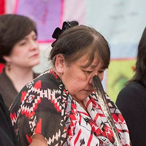 Bella Bresse holds an eagle feather as she pauses for a moment while speaking about her murdered daughter, Evangeline Kris Bresse, at the National Inquiry into Missing and Murdered Indigenous Women and Girls taking place in Whitehorse, YT., Wednesday, May 31, 2017. (Jonathan Hayward/CP)