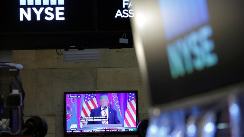 U.S. President-elect Donald Trump is broadcast on a screen on the floor at the New York Stock Exchange (NYSE) in Manhattan, New York City, U.S. December 27, 2016. REUTERS/Andrew Kelly - RTX2WN66