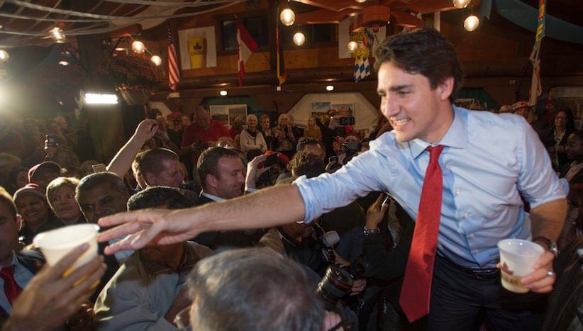 Liberal Leader Justin Trudeau serves a beer to an attendee during an Oktoberfest celebration in Kitchener, Ont., on Tuesday, October 13, 2015. THE CANADIAN PRESS/Paul Chiasson