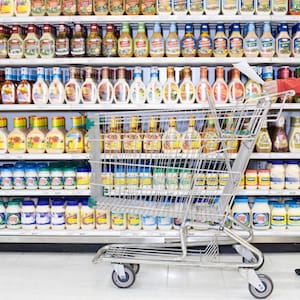Shopper checking list in supermarket aisle